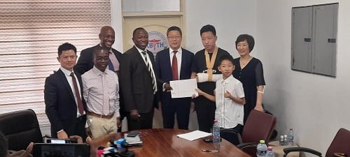 FOUNDATION-1-Mr-Mensah-second-left-Mr-Shen-fourth-right-and-his-family-exchanging-the-MoU-with-Dr-Ampomah-fourth-left-after-the-launch-and-signing-ceremony.jpg