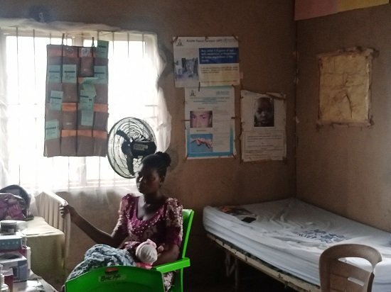A-nursing-mother-at-Odoladalepo-with-her-baby-sitting-on-a-chair-provided-by-BHCF-at-Odoladalepo-PHC-Ijebu-LGA.jpg