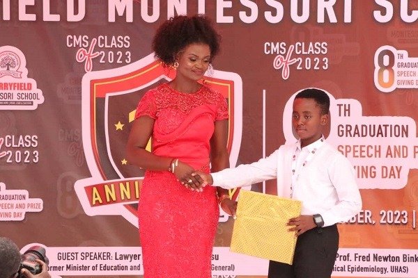 WAEC-Ms-Dzifa-Adjanu-presenting-one-of-the-pupils-with-his-award.jpg